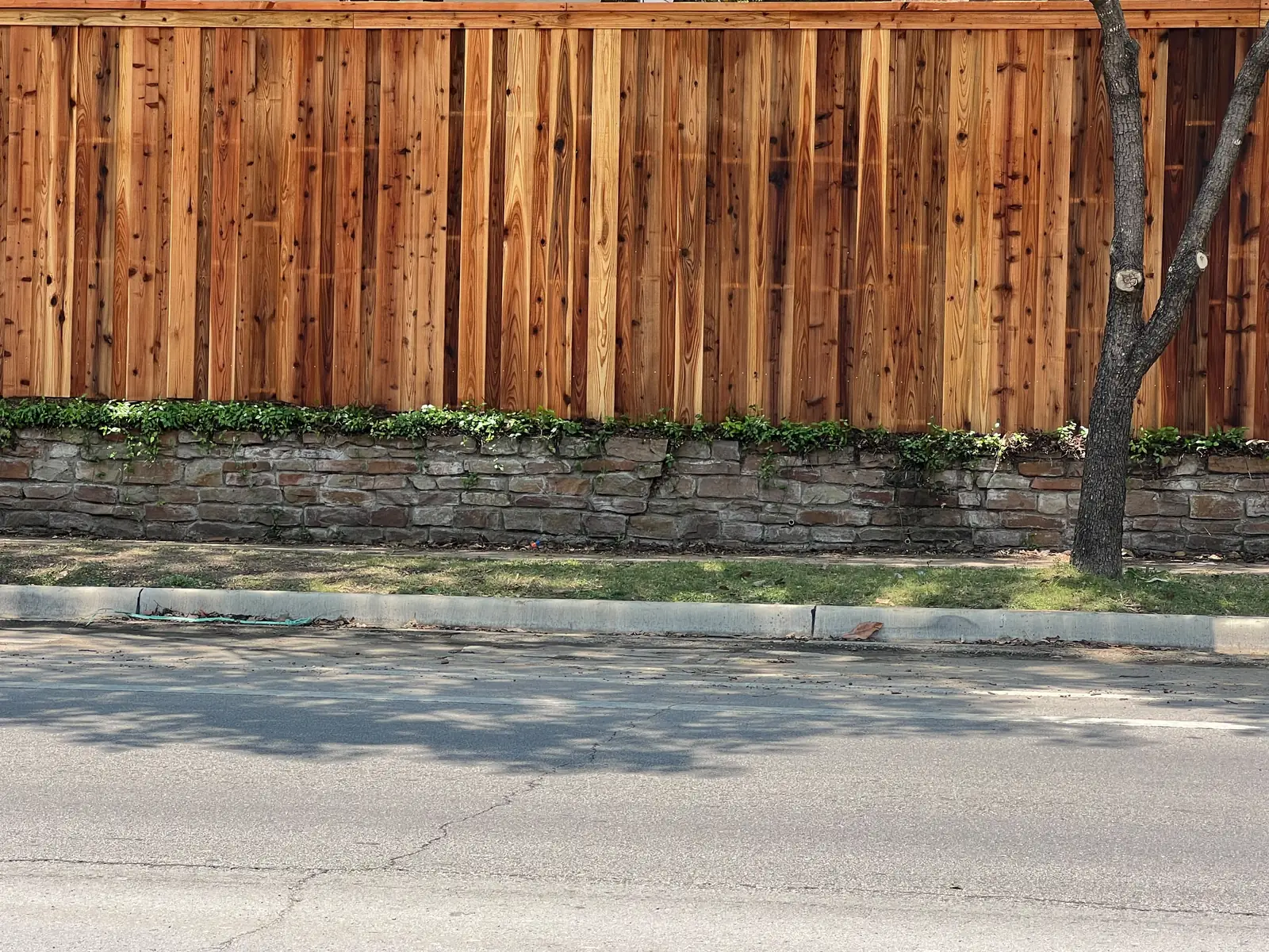 Cedar cap-rail fence on a stone retaining wall