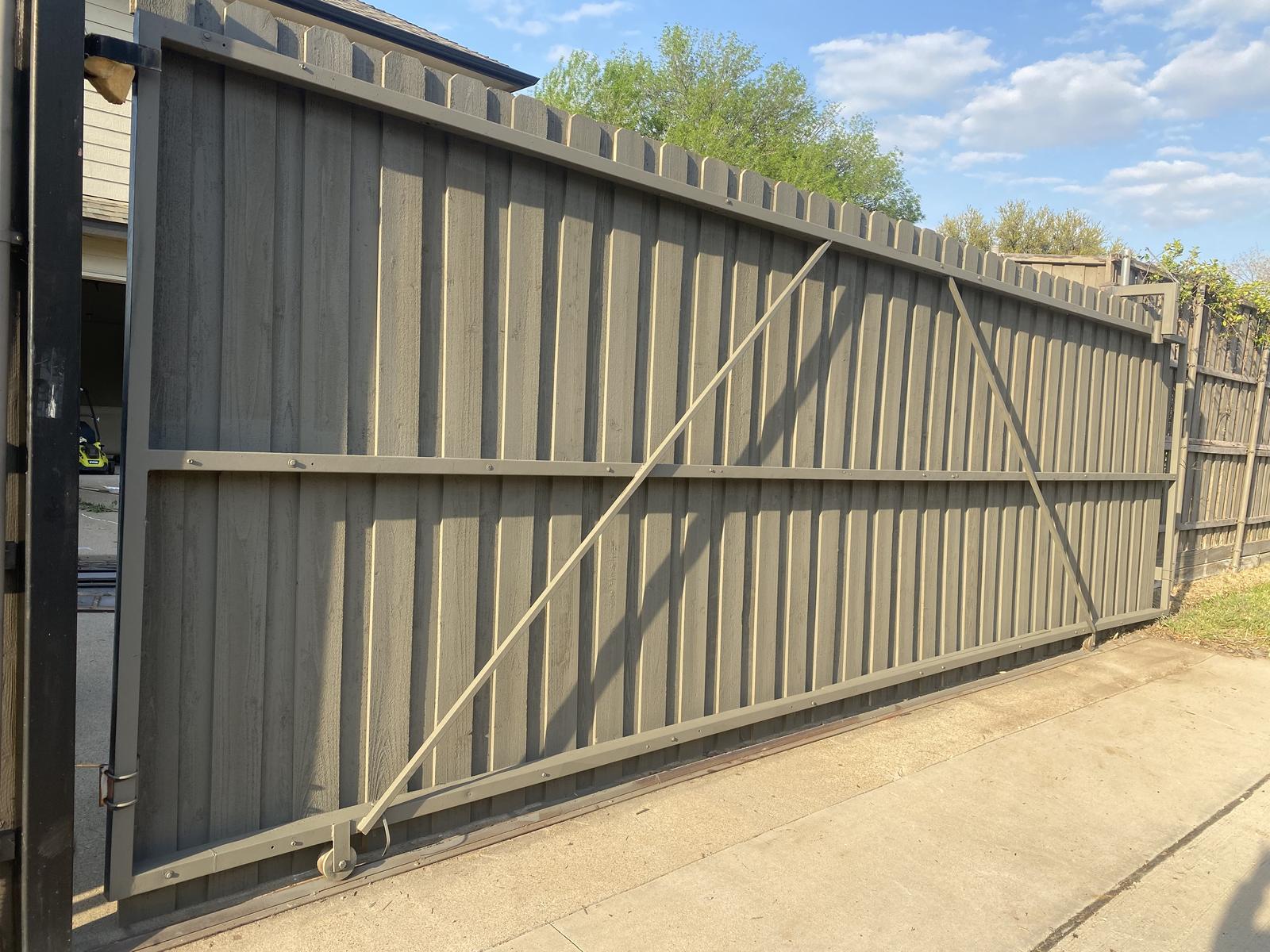 Painted sliding driveway gate with bracing and track wheel