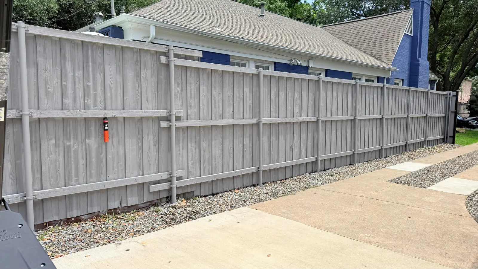 Steel sliding gate closed across a new concrete drive