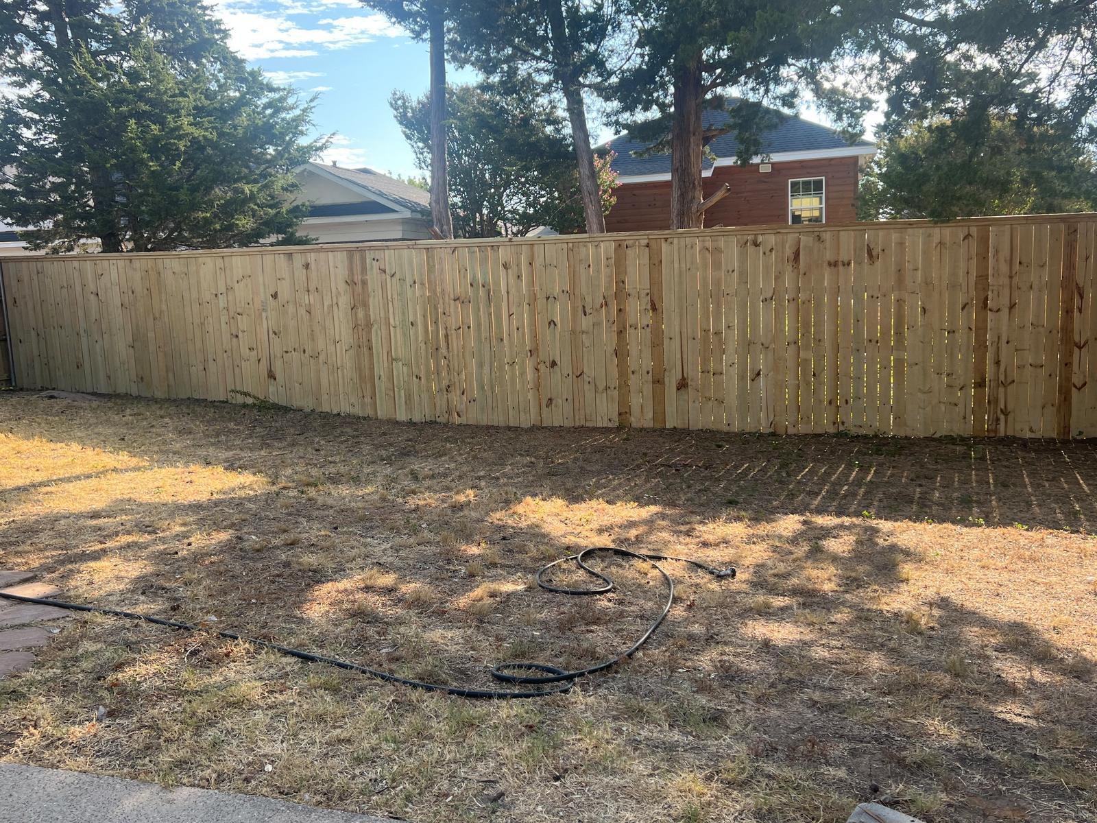 Pine cap-rail fence in a backyard rebuild