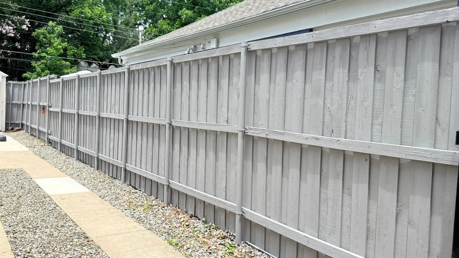 Painted board-on-board running the length of a fresh gravel path