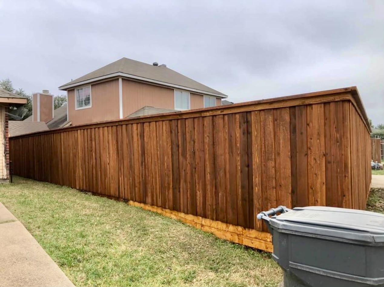Cedar-tone stained fence with cap rail
