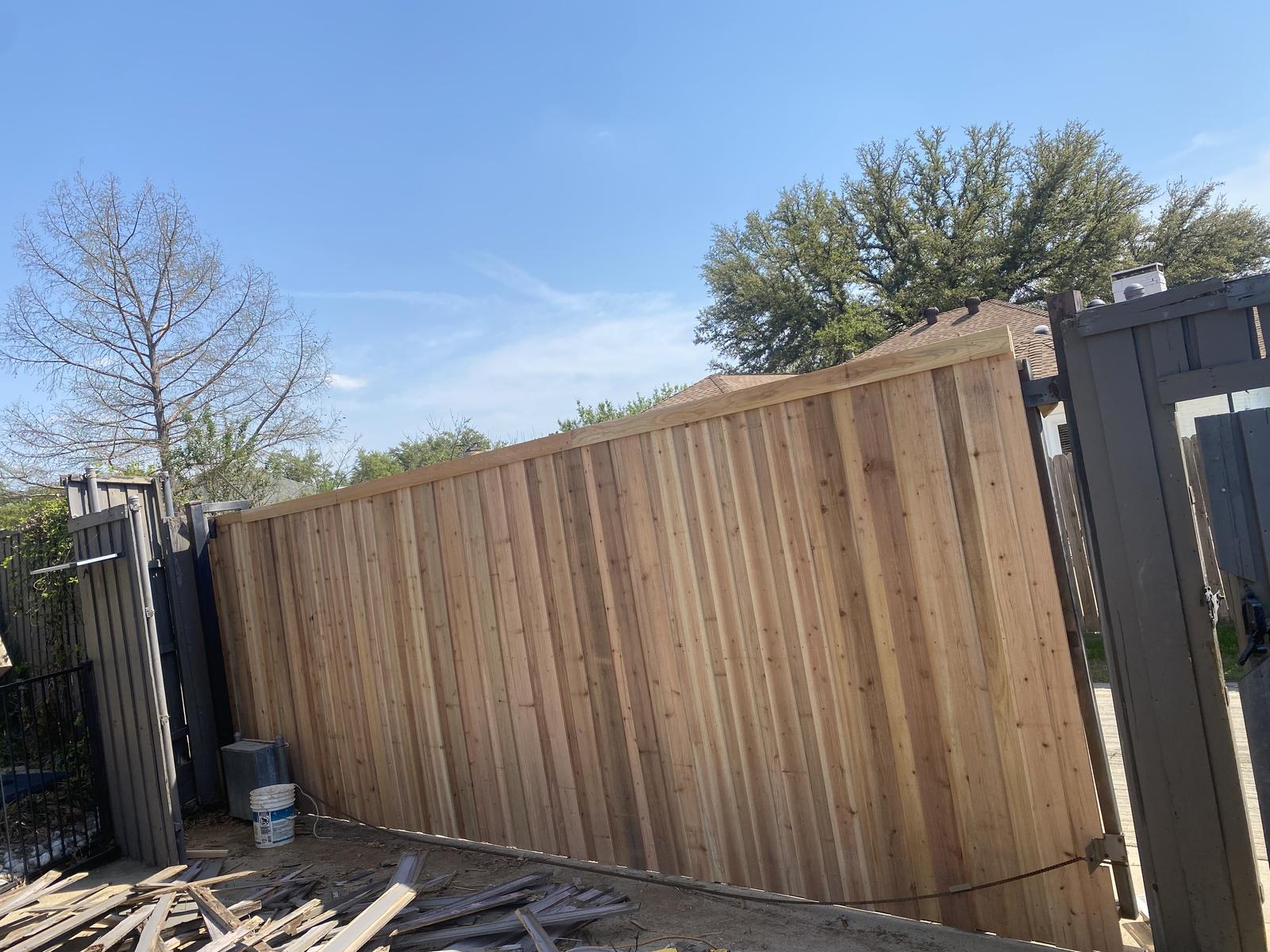 Cedar-clad sliding gate with old panels removed