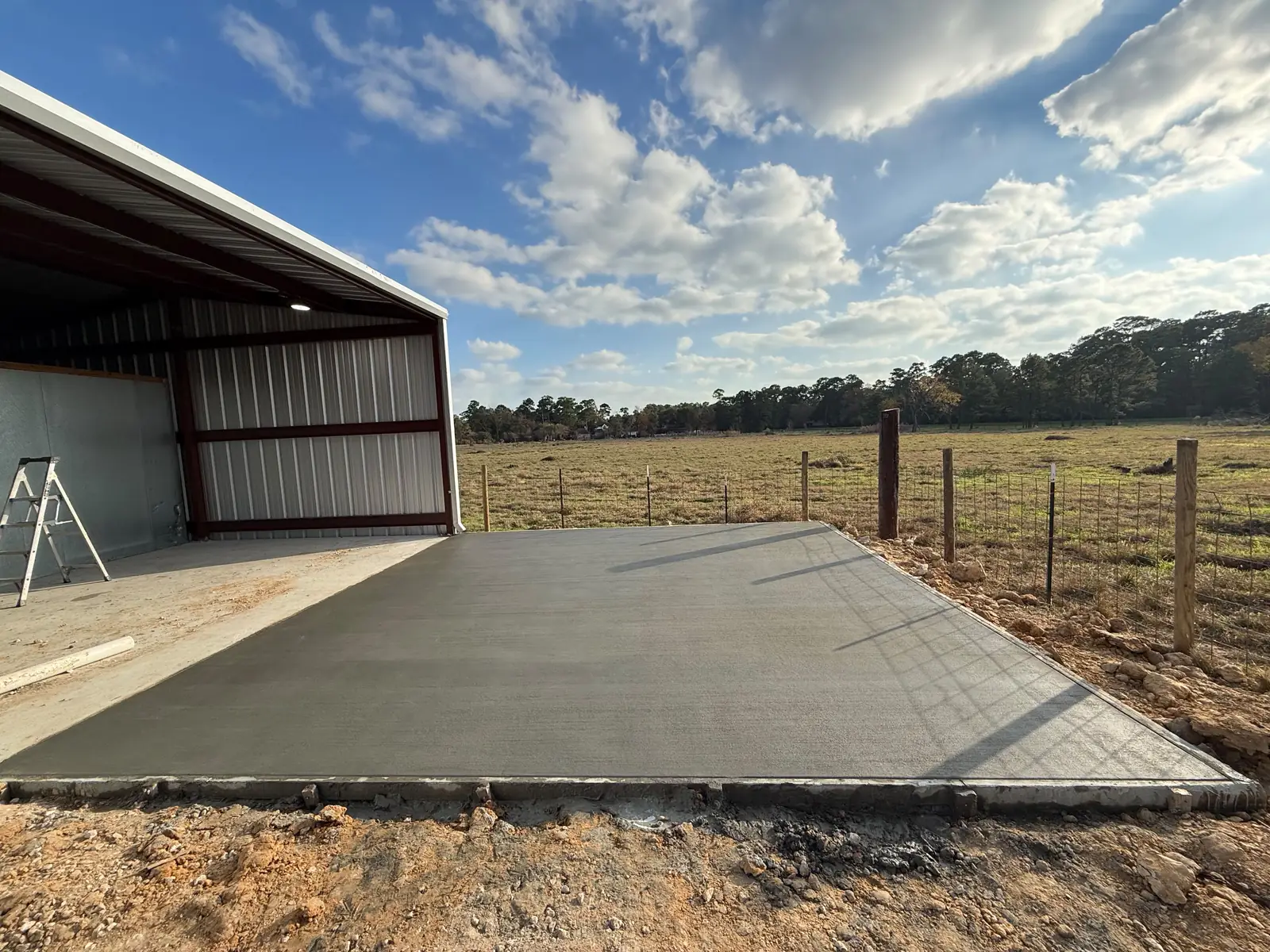 Freshly poured concrete slab at a metal building