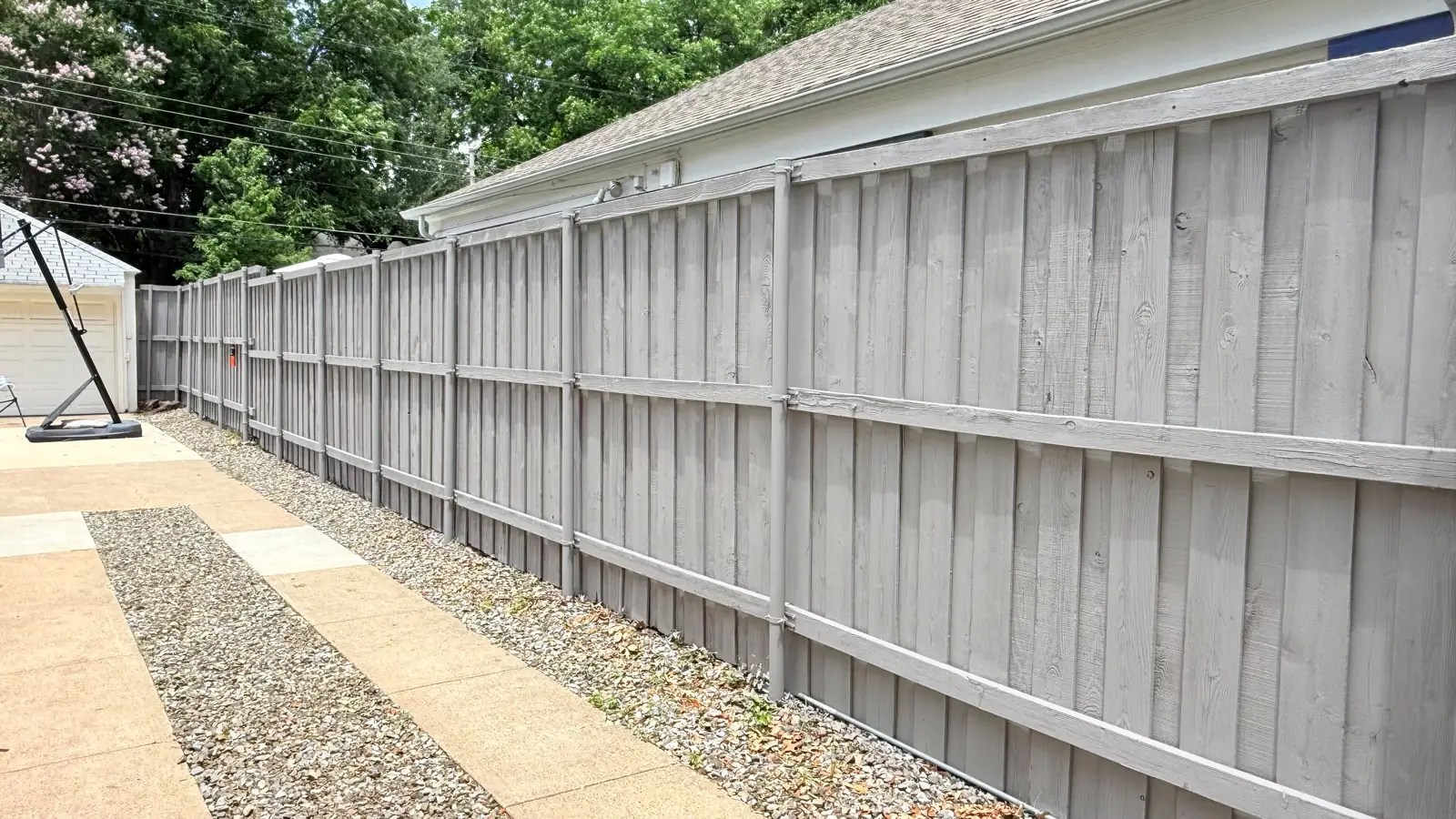 Gray painted board-on-board fence with steel posts