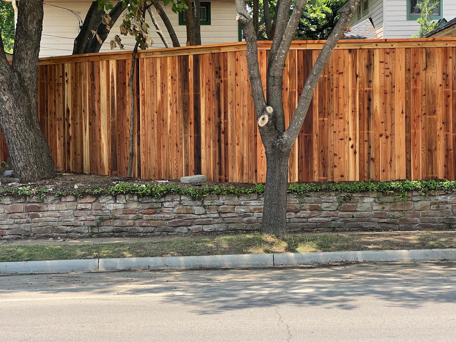 Cedar cap-rail fence street side with trees