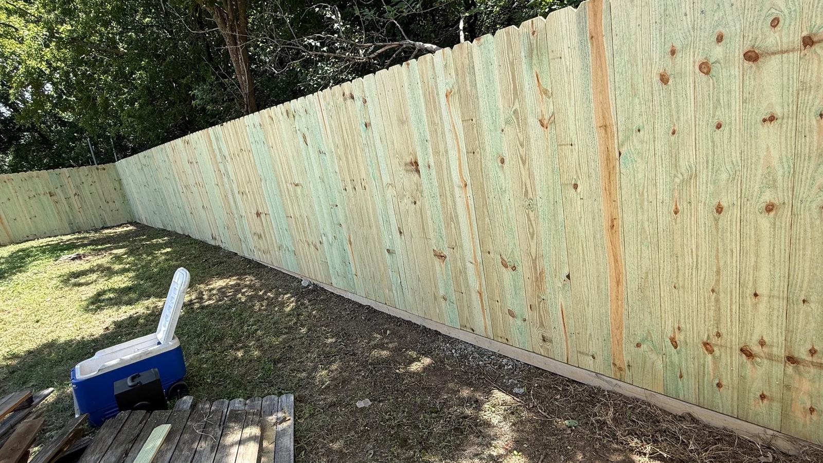 New pressure-treated pine privacy fence