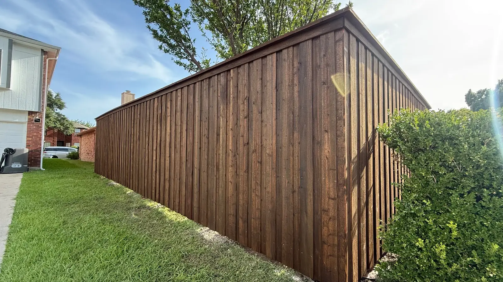 Finished fence with cap rail and stain